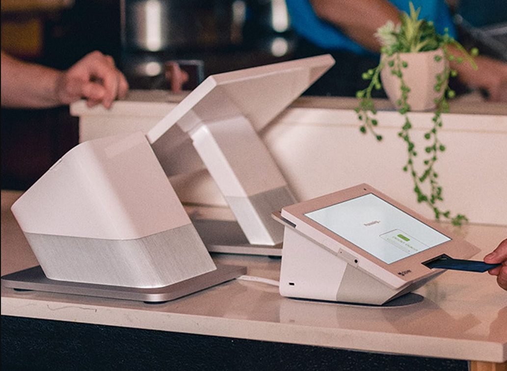 A Clover Station and Clover Flex terminal set up on a café counter